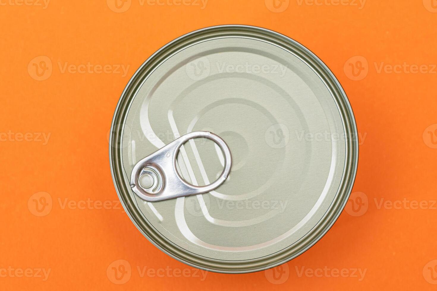 Unopened Tin Can with Blank Edge on Orange Background. Canned Food. Aluminum Can for Safe and Long Term Storage of Food. Steel Sealed Food Storage Container photo