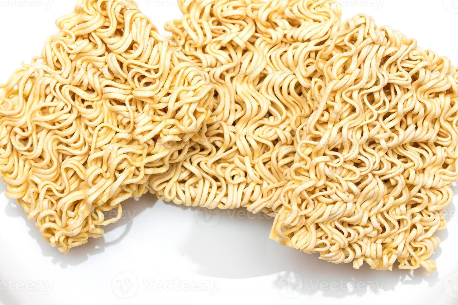Uncooked Instant Noodles on White Plate. Raw Pasta. Dry Asian Fast Food. Quick Lunch photo