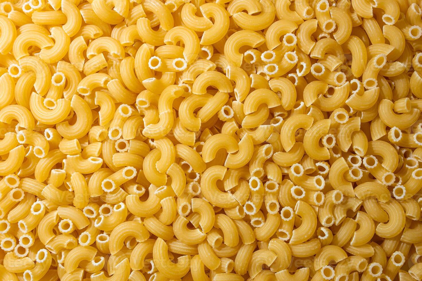 Uncooked Chifferi Rigati Pasta. A Culinary Canvas of Chifferi Rigati, Creating a Lively and Textured Background for Gourmet Cooking. Dry Pasta. Raw Macaroni - Top View, Flat Lay photo