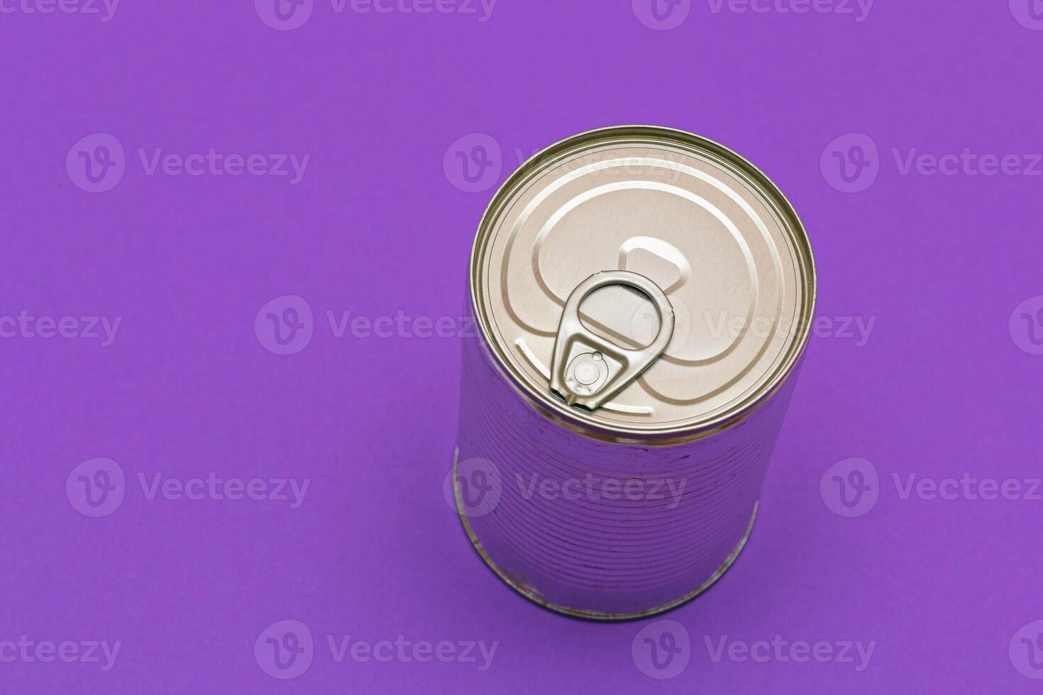 Unopened Tin Can with Blank Edge on Violet Background. Canned Food. Aluminum Can for Safe and Long Term Storage of Food. Steel Sealed Food Storage Container photo