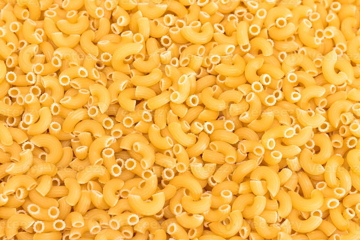 Uncooked Chifferi Rigati Pasta Background. Fat and Unhealthy Food. Classic Dry Macaroni Texture. Italian Culture and Cuisine. Raw Pasta photo
