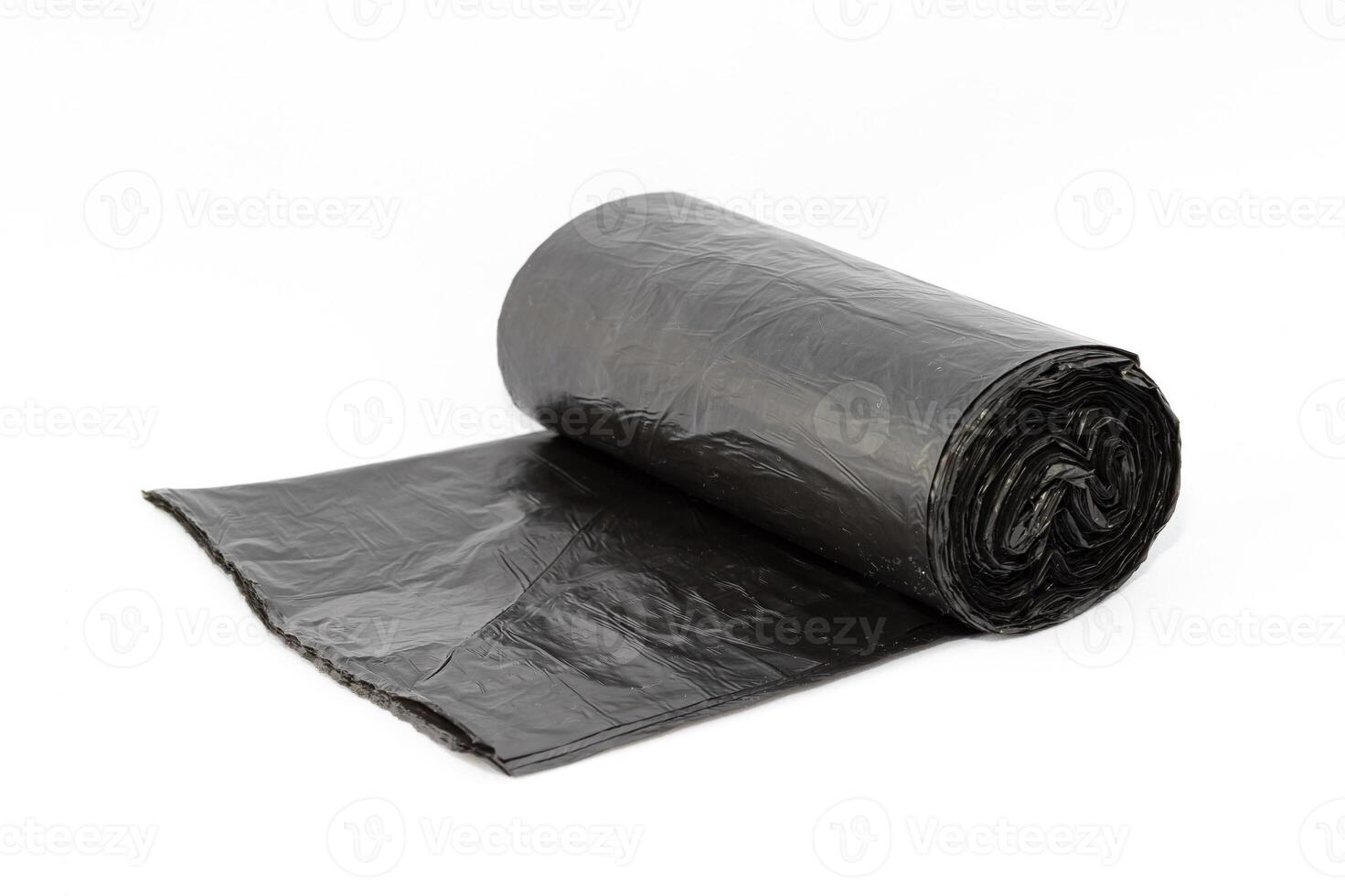 Black Polyethylene Garbage Bags on White Background - Close-Up. The Roll of Plastic Junk Package photo