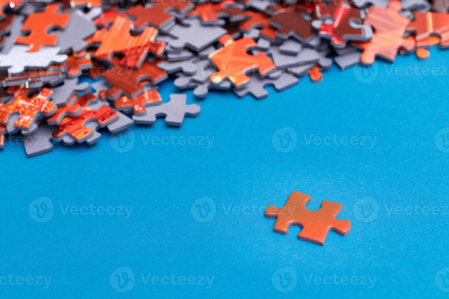 Mixed Pieces of a Colorful Jigsaw Puzzle Lie on the Blue Background - Strategy and Solving Problem Concept photo
