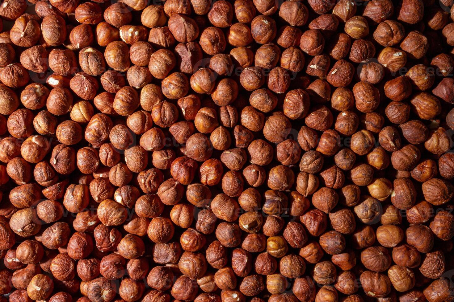 Scattered Peeled Hazelnut - Top View. Background from Hazelnuts. Natural High-Calorie Snacks photo