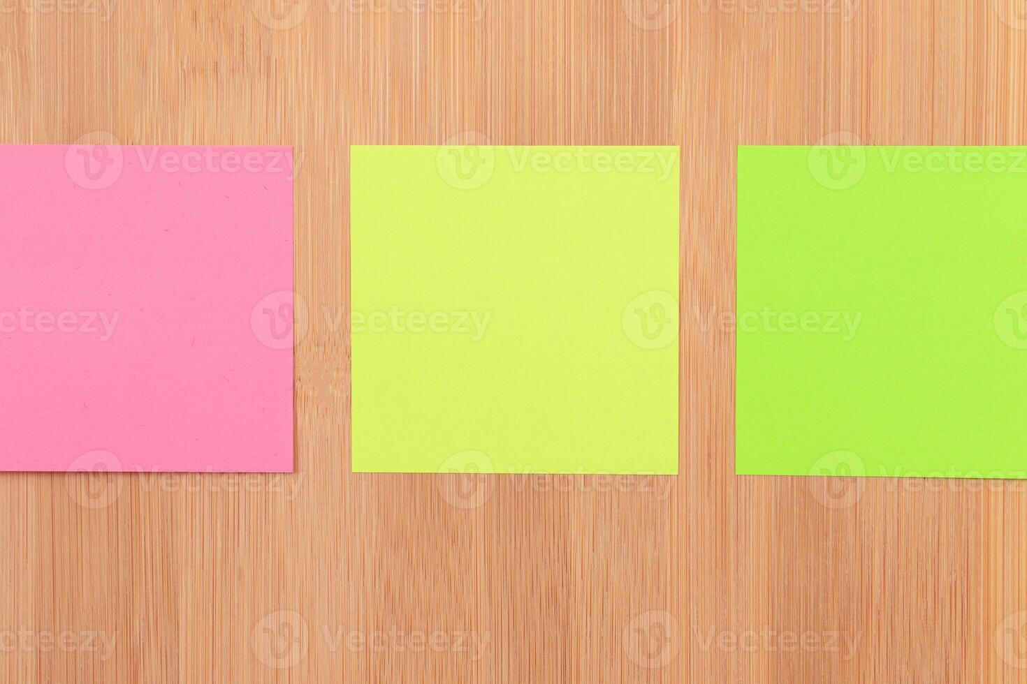 Colored Sticky Notes with Copyspace Pinned to the Wooden Message Board. To Do List Reminder in Office. Blank Memo Sticker at Work - Template. Empty Checklist - Mockup photo