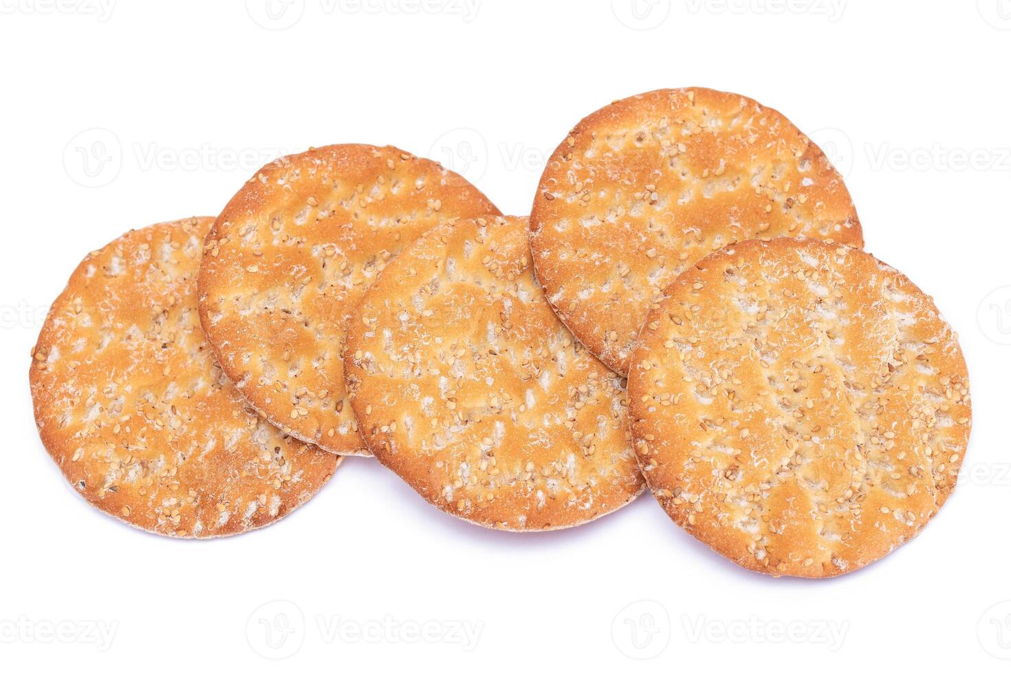 A Heap of Round Salt Crackers with Sesame Isolated on White Background. Dry Snacks - Isolation photo