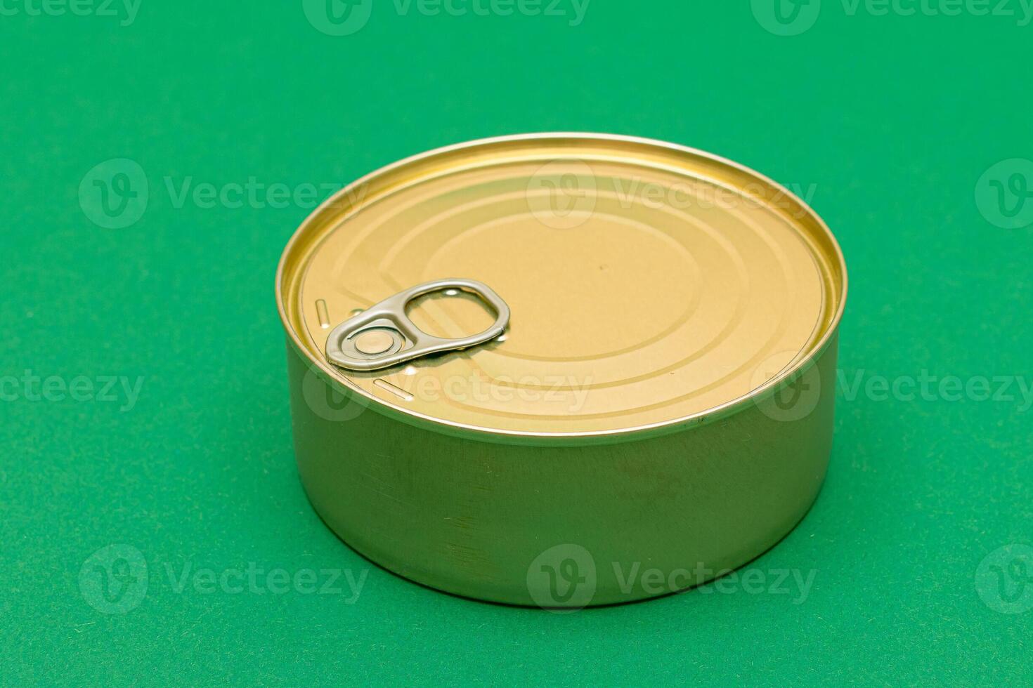 Unopened Tin Can with Blank Edge on Green Background. Canned Food. Aluminum Can for Safe and Long Term Storage of Food. Steel Sealed Food Storage Container photo