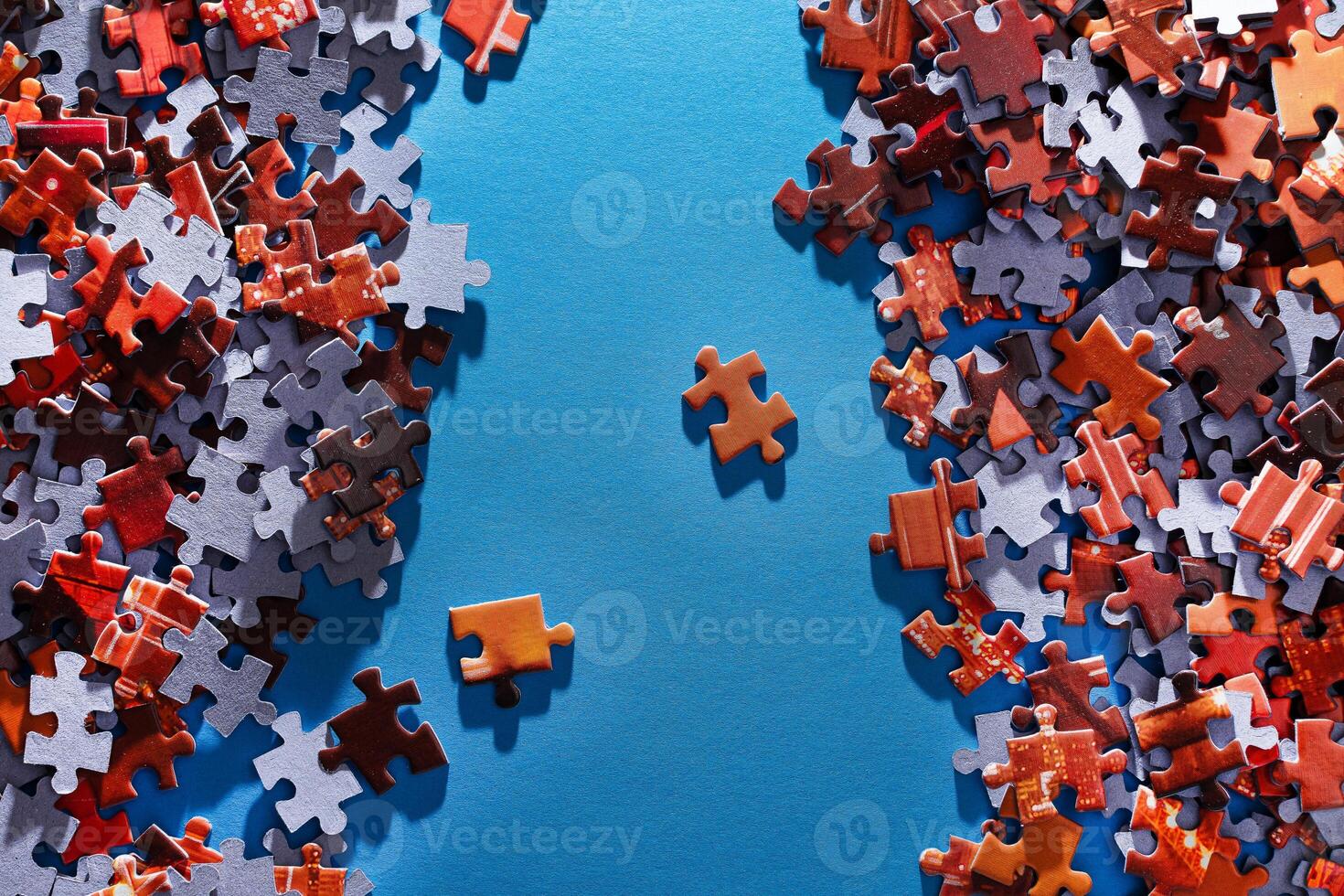 Mixed Pieces of a Colorful Jigsaw Puzzle Lie on the Blue Background - Strategy and Solving Problem Concept photo
