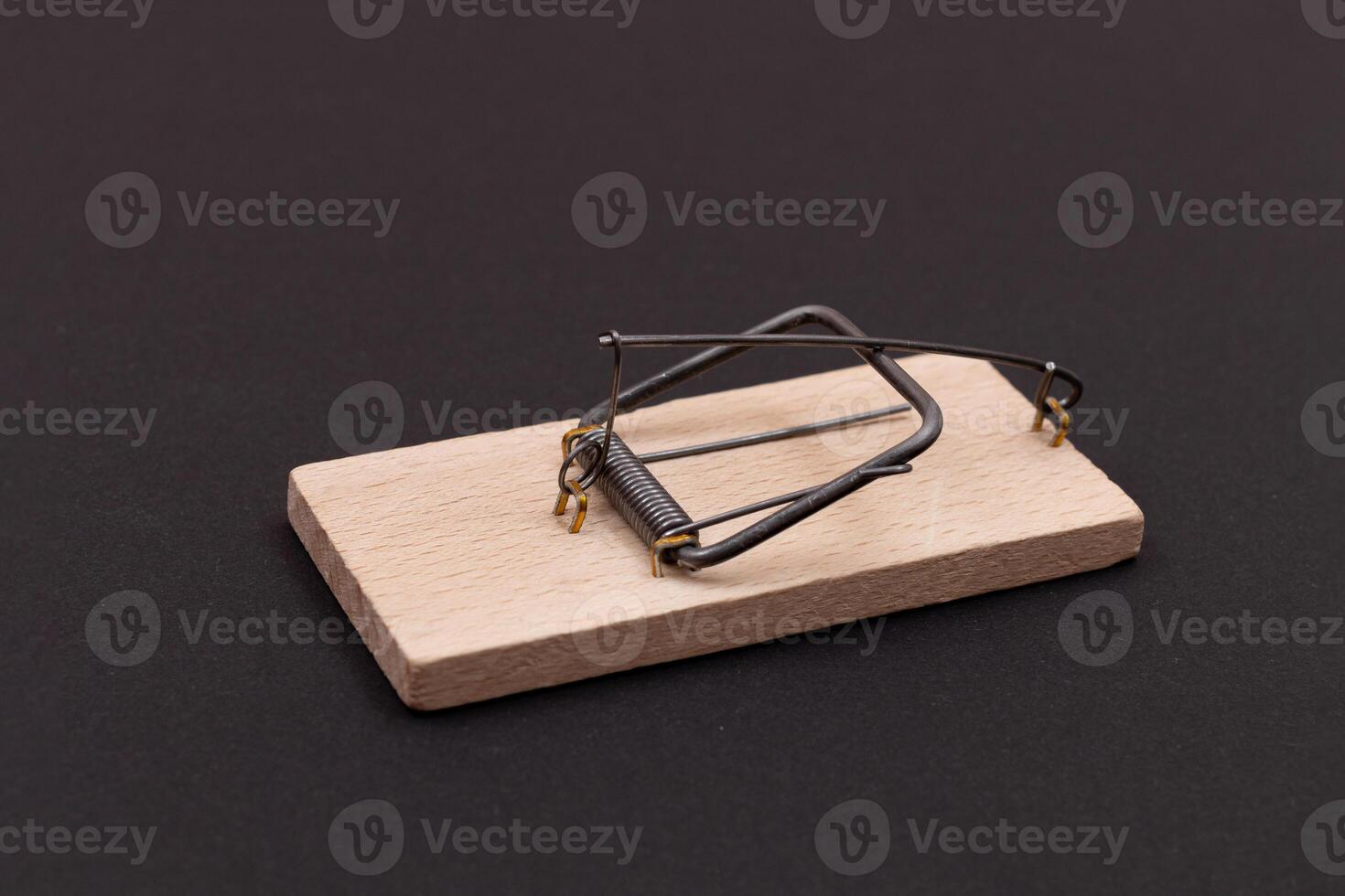 Wooden Mouse Trap. Empty Loaded Mousetrap on Black Background photo