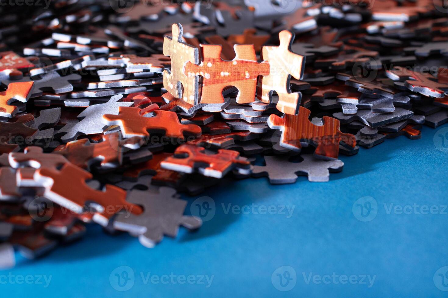 Mixed Pieces of a Colorful Jigsaw Puzzle Lie on the Blue Background - Strategy and Solving Problem Concept photo