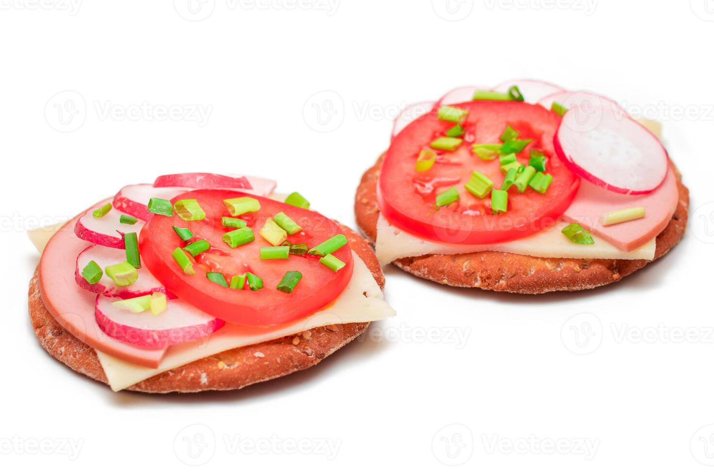 Crispy Cracker Sandwiches with Tomato, Sausage, Cheese, Green Onions and Radish - Isolated on White. Easy Breakfast. Diet Food. Quick and Healthy Sandwiches. Crispbread with Tasty Filling - Isolation photo
