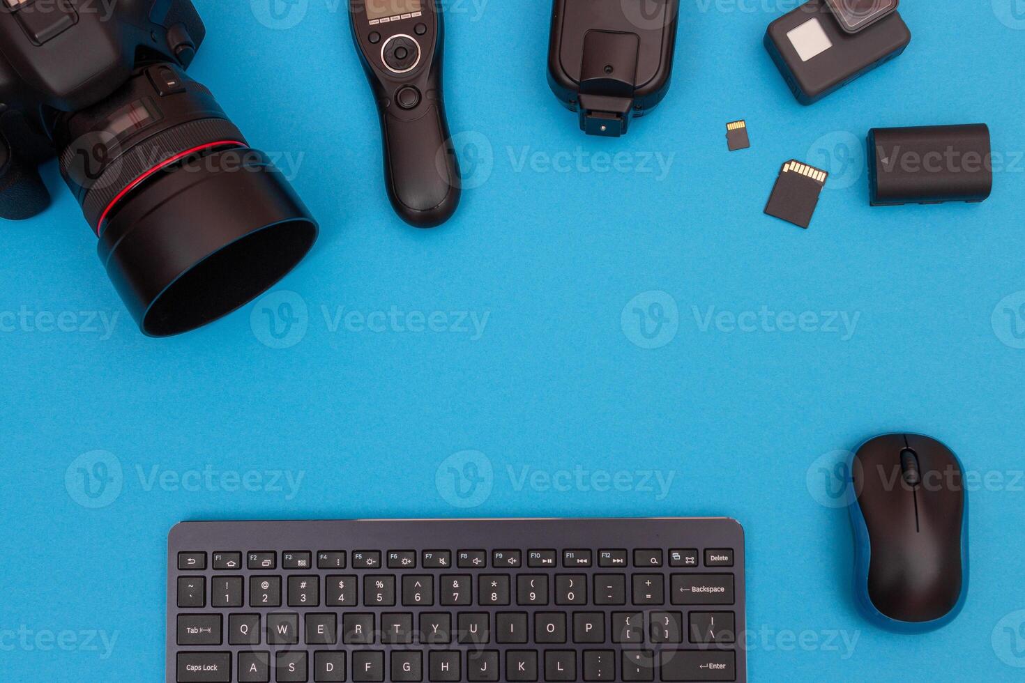 Top View of Photographer's, Videographer's or Blogger's Workplace. Digital Gadgets Lying on Blue Table - Flat Lay photo