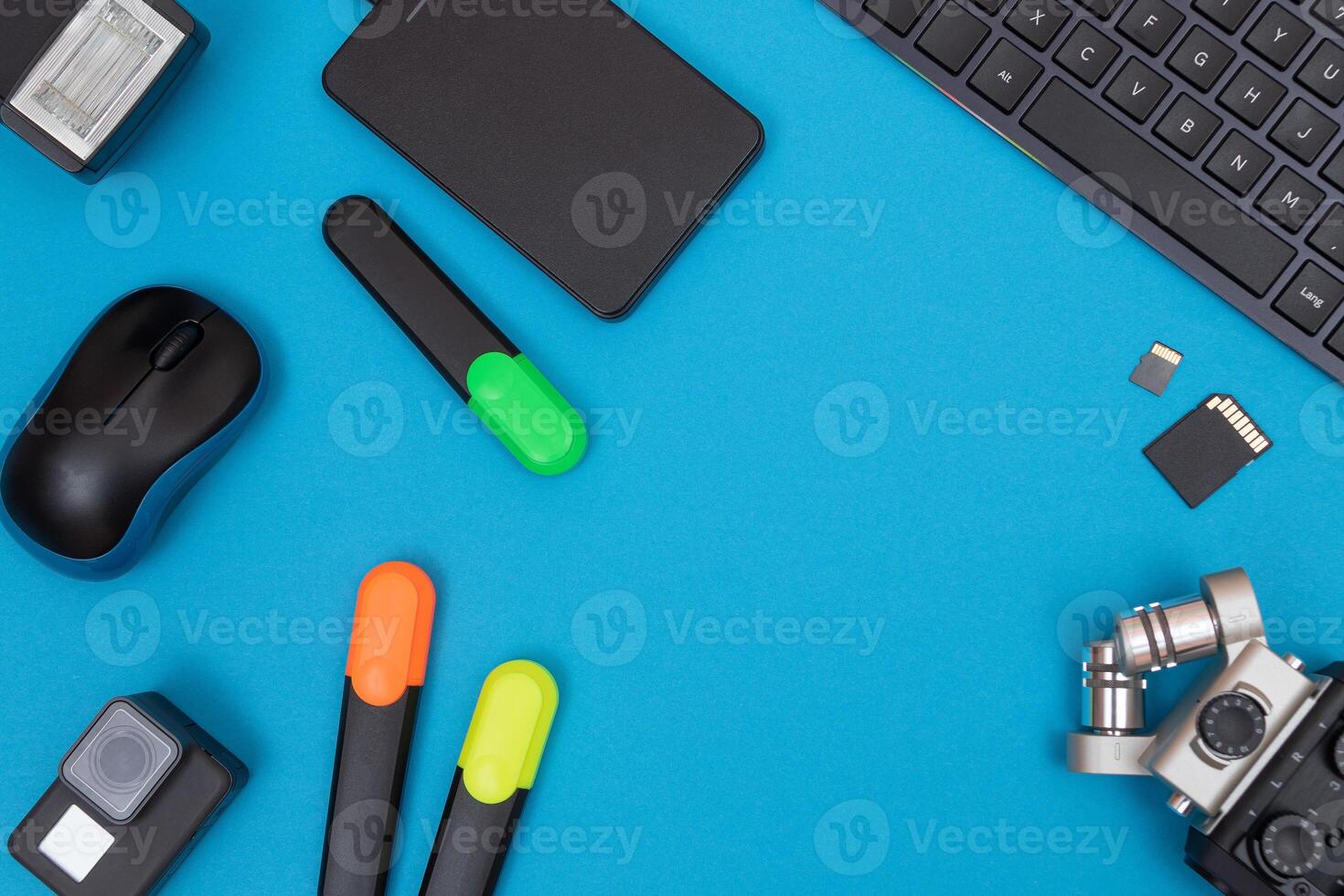 Top View of Photographer's, Videographer's or Blogger's Workplace. Digital Gadgets Lying on Blue Table - Flat Lay photo