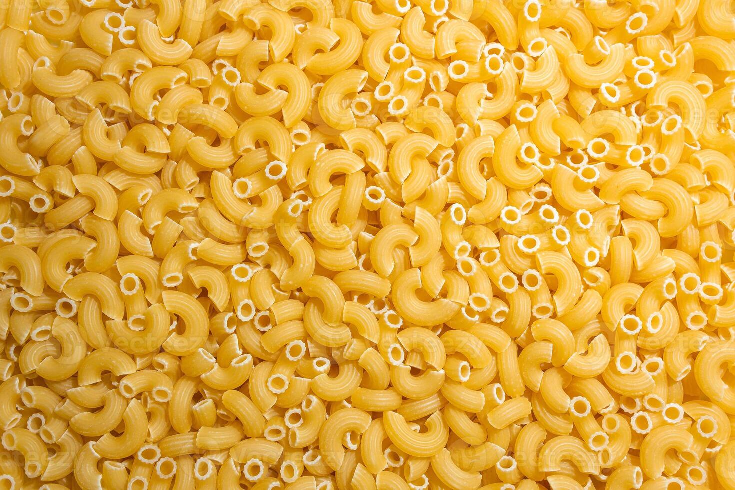 Uncooked Chifferi Rigati Pasta. A Culinary Canvas of Chifferi Rigati, Creating a Lively and Textured Background for Gourmet Cooking. Dry Pasta. Raw Macaroni - Top View, Flat Lay photo