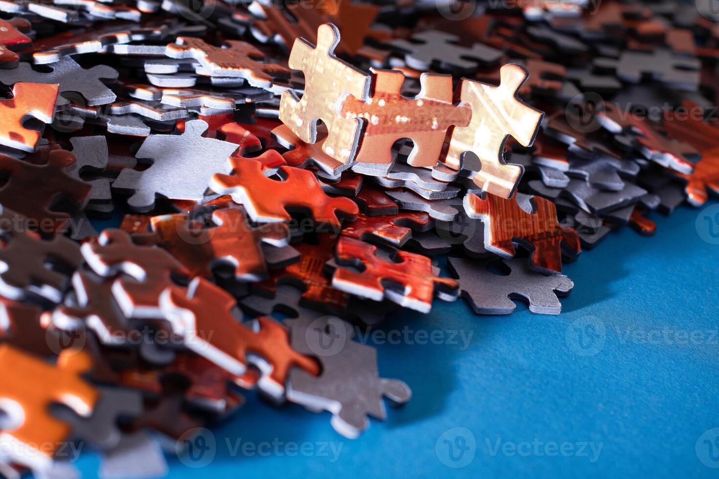 Mixed Pieces of a Colorful Jigsaw Puzzle Lie on the Blue Background - Strategy and Solving Problem Concept photo