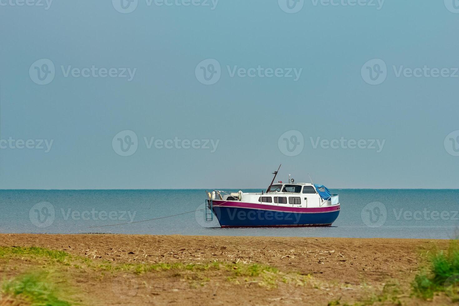 Small blue passenger ship moored at Baltic sea bay photo