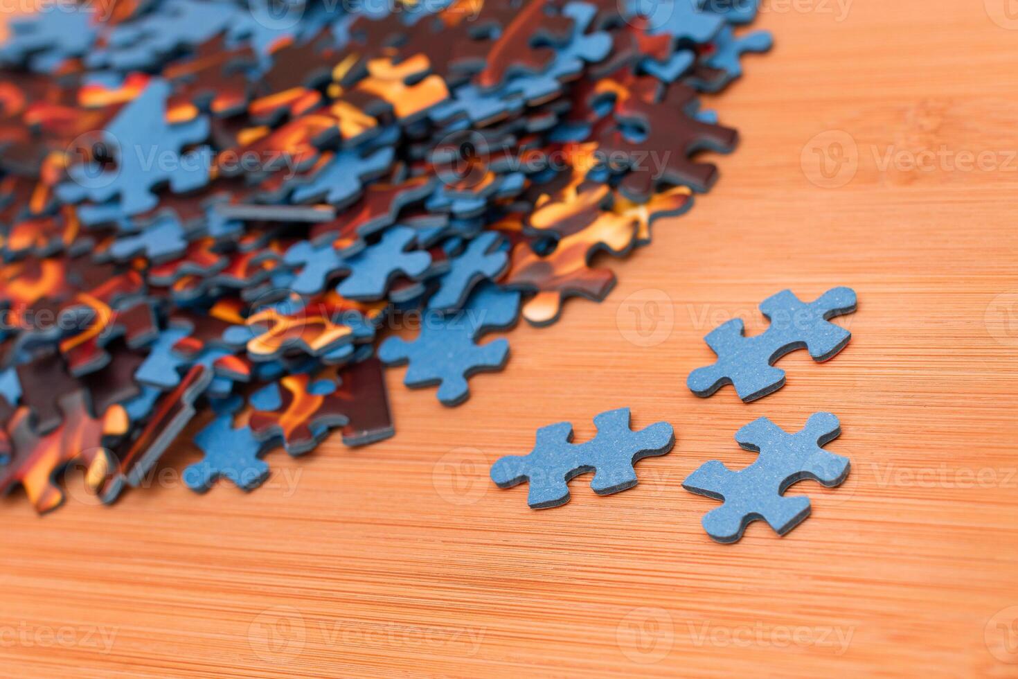 Colorful Pieces of a Mixed Jigsaw Puzzle Lie on the Wooden Table - Strategy and Solving Problem Concept photo
