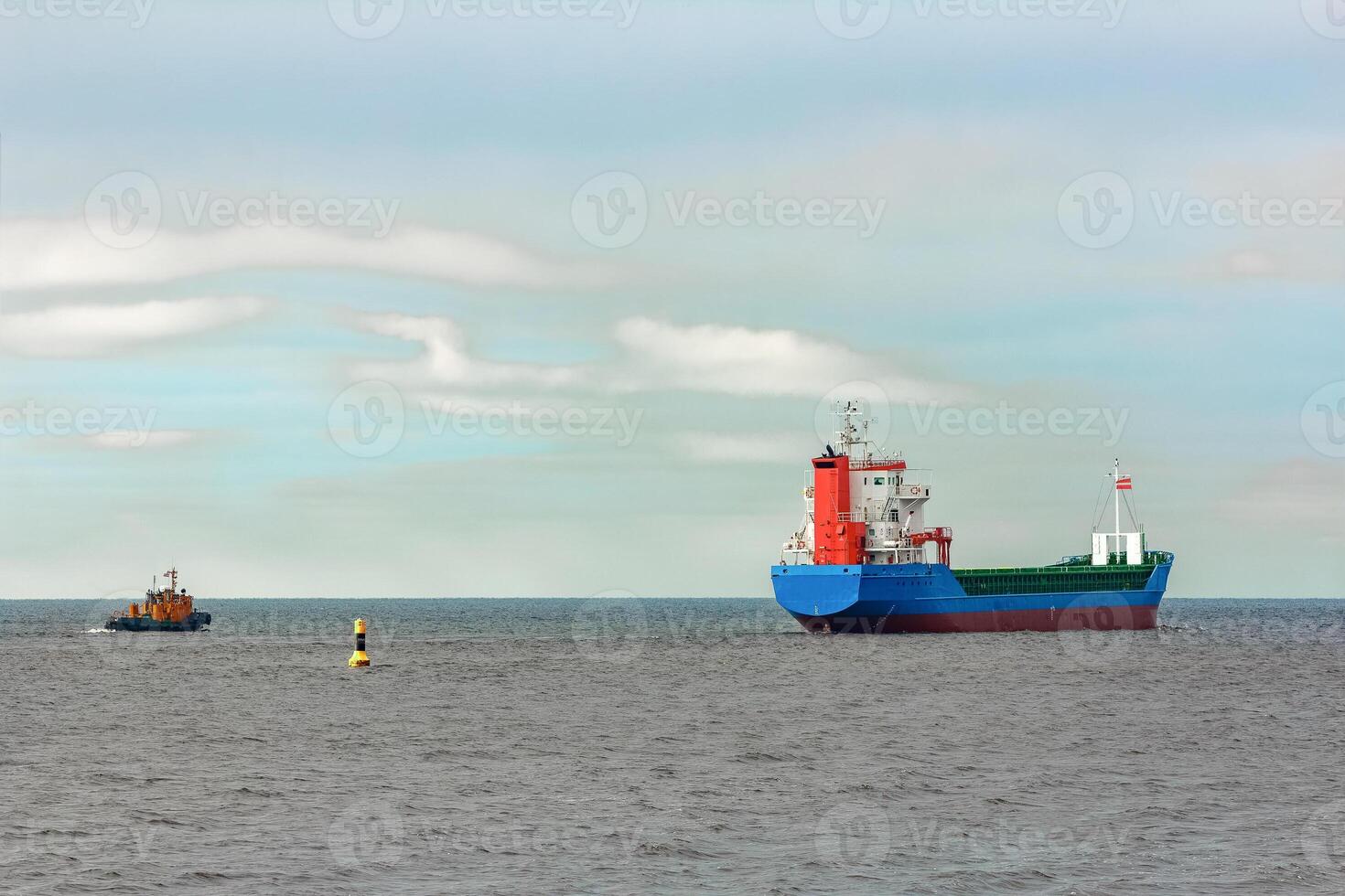 Blue cargo ship entering the Baltic sea. Riga, Europe photo