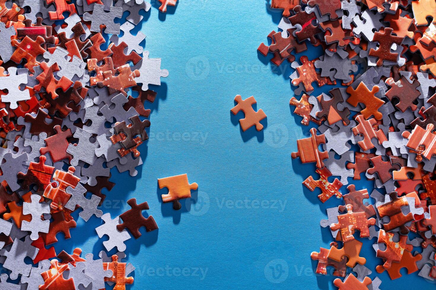Mixed Pieces of a Colorful Jigsaw Puzzle Lie on the Blue Background - Strategy and Solving Problem Concept photo