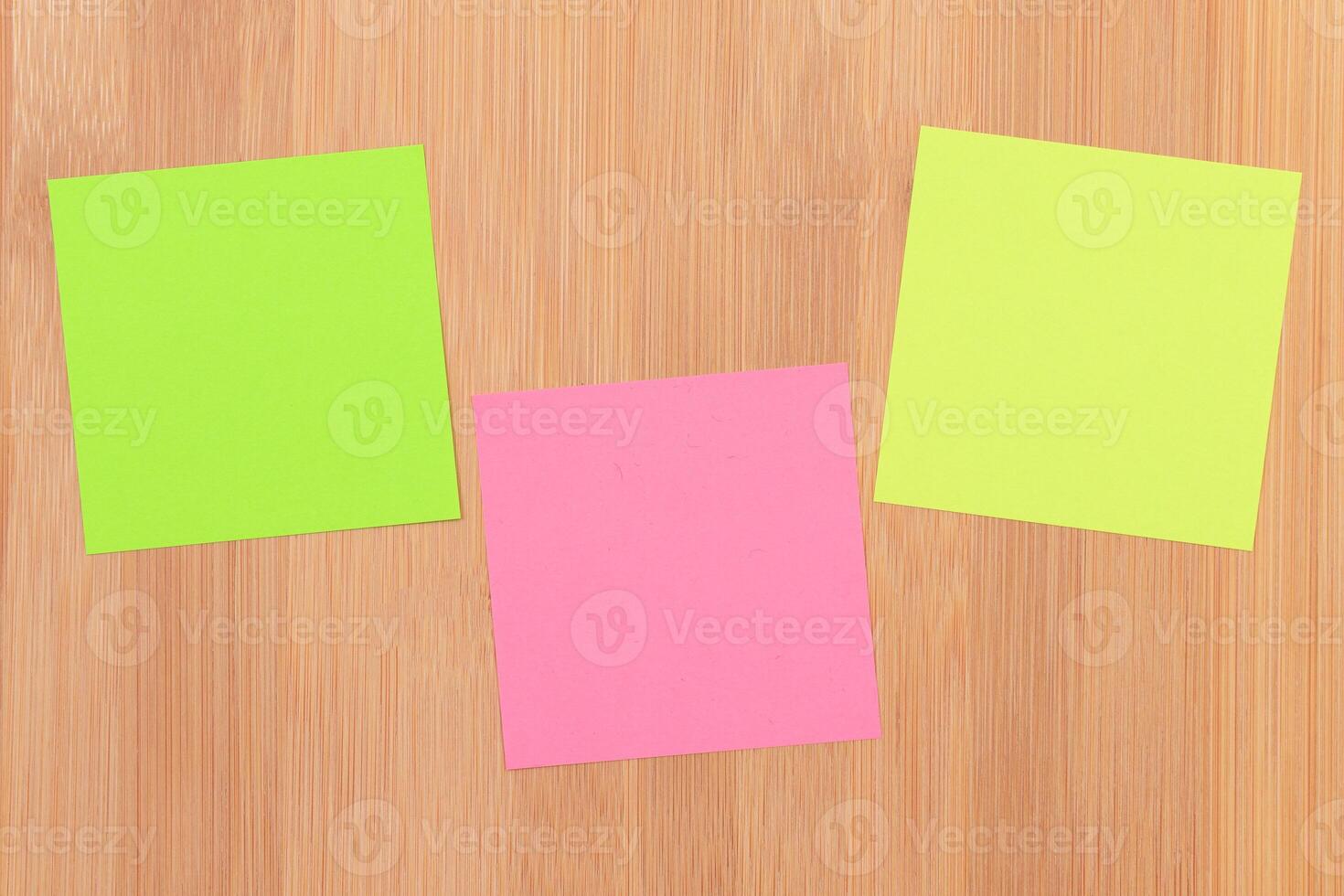 Colored Sticky Notes with Copyspace Pinned to the Wooden Message Board. To Do List Reminder in Office. Blank Memo Sticker at Work - Template. Empty Checklist - Mockup photo