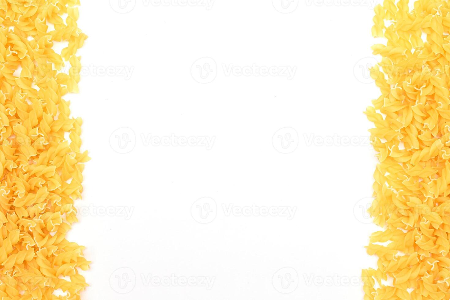 Uncooked Fusilli Pasta with Copy Space on White Background. Raw and Dry Macaroni. Fat and Unhealthy Food - Flat Lay photo
