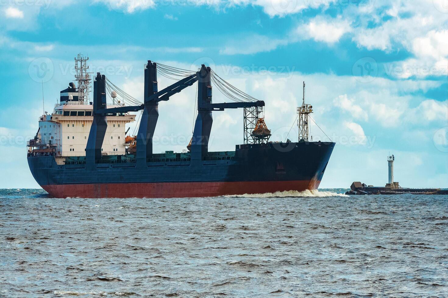 Merchandise import. Large blue cargo ship moving to Riga port photo