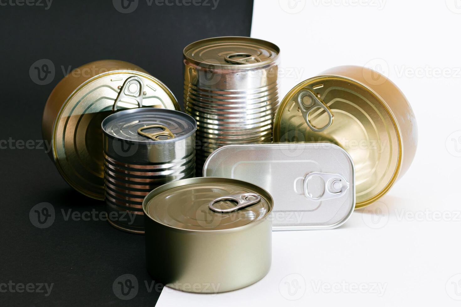 A Group of Stacked Tin Cans with Blank Edges on Split Black and White Background. Canned Food. Different Aluminum Cans for Safe and Long Term Storage of Food. Steel Sealed Food Storage Containers photo