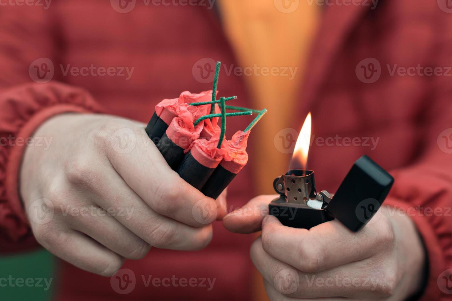 Man in Red Jacked Lighting Up Several Firecrackers in his Hand Using Gasoline Lighter. Guy Getting Ready for New Year Fun with Fireworks or Pyrotechnic Products photo