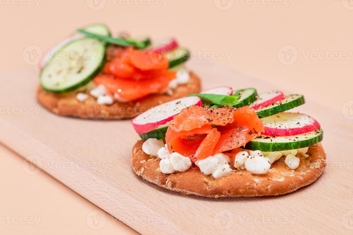 Crispy Cracker Sandwiches with Fresh Salmon, Cucumber, Radish, Cottage Cheese and Green Onions. Easy Breakfast. Quick and Healthy Sandwiches. Crispbread with Tasty Filling. Healthy Dietary Snack photo