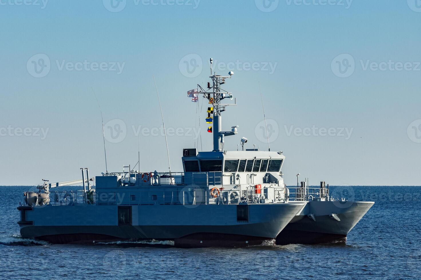 Small grey military ship moving from Baltic sea photo
