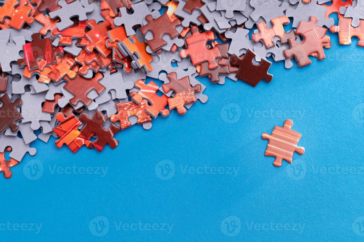 Mixed Pieces of a Colorful Jigsaw Puzzle Lie on the Blue Background - Strategy and Solving Problem Concept photo