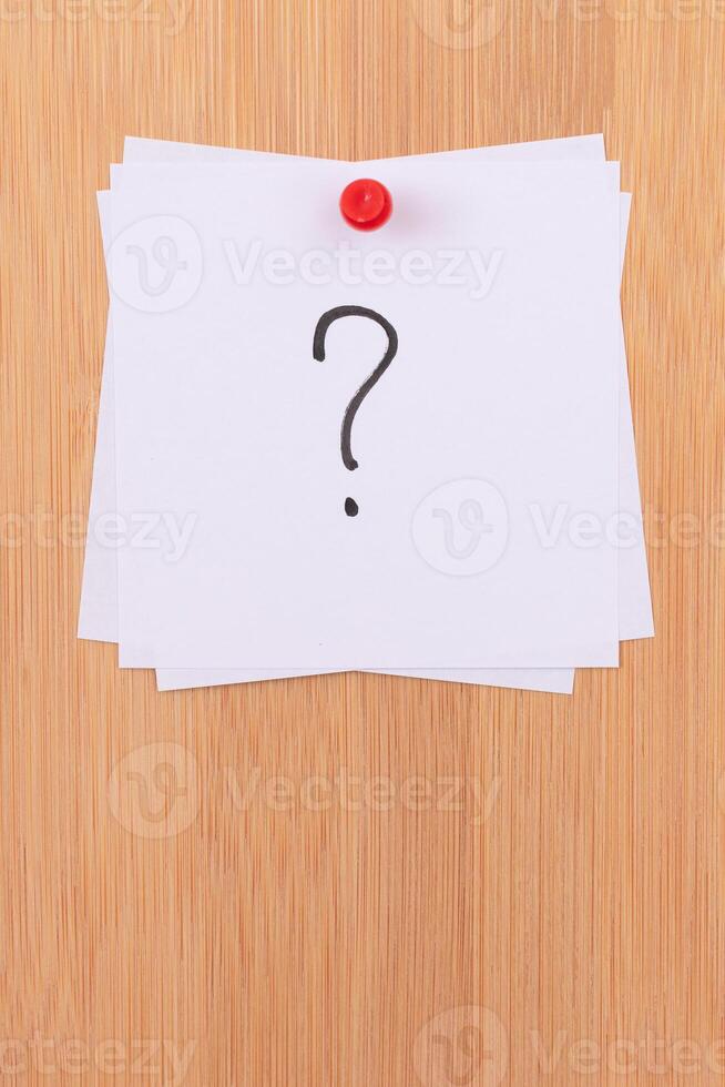 White Sticky Notes with Question Mark Pinned to the Wooden Message Board. To Do List Reminder in the Office. Memo Note at Work photo