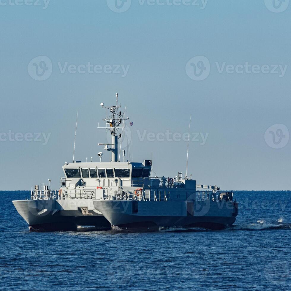 Small grey military ship moving from Baltic sea photo