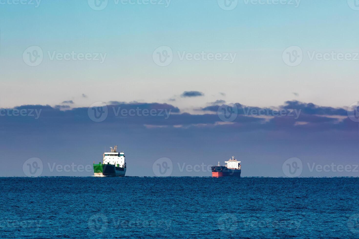 Cargo ships far in still water of Baltic sea photo