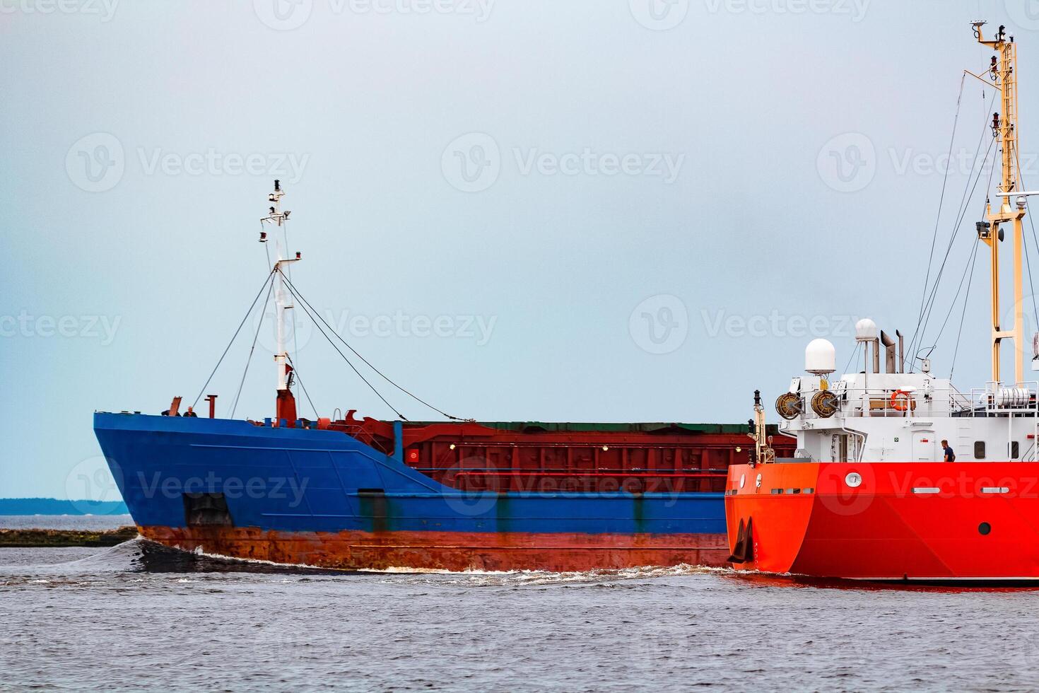 Merchandise import. Large blue cargo ship moving to Riga port photo