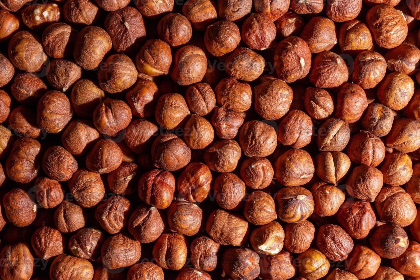 Scattered Peeled Hazelnut - Top View. Background from Hazelnuts. Natural High-Calorie Snacks photo