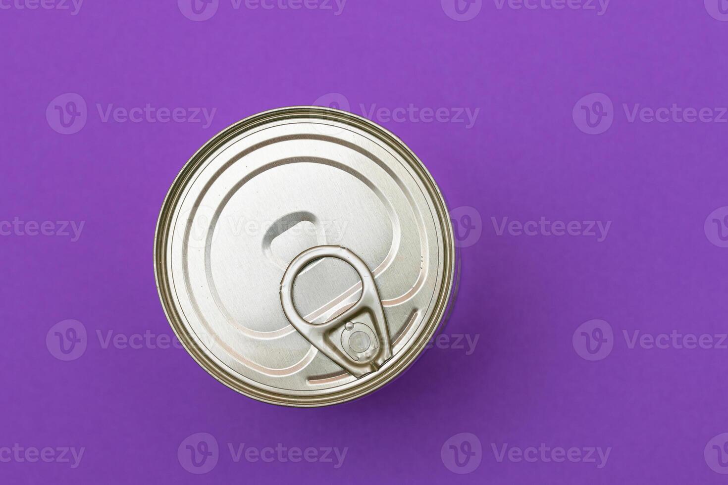 Unopened Tin Can with Blank Edge on Violet Background. Canned Food. Aluminum Can for Safe and Long Term Storage of Food. Steel Sealed Food Storage Container photo