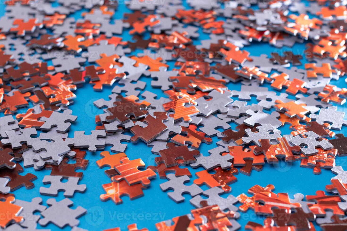 Mixed Pieces of a Colorful Jigsaw Puzzle Lie on the Blue Background - Strategy and Solving Problem Concept photo