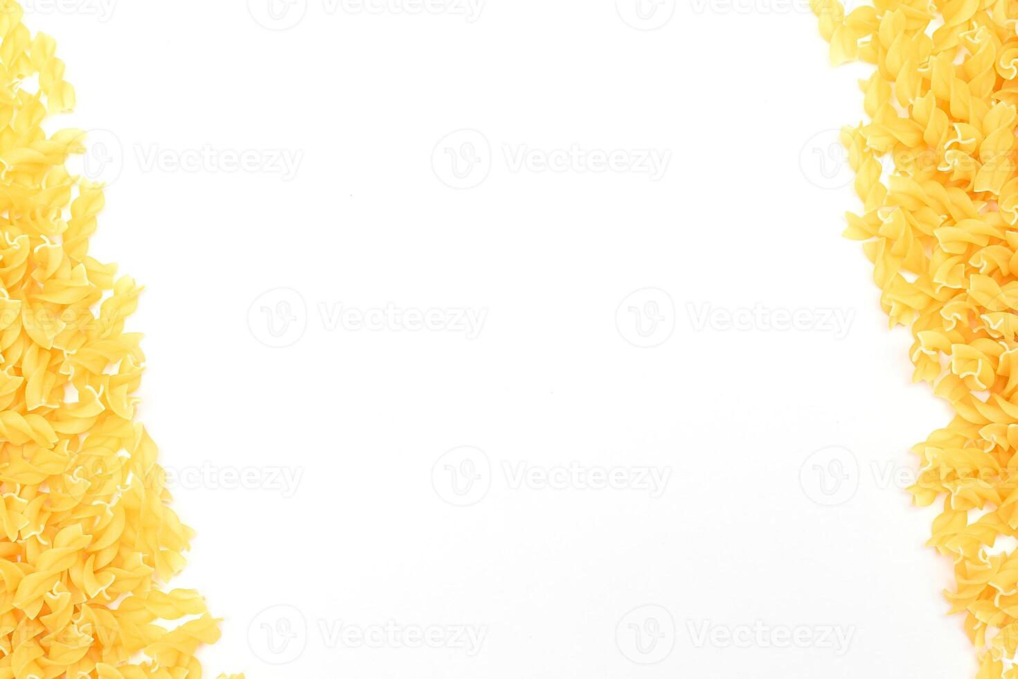 Uncooked Fusilli Pasta with Copy Space on White Background. Raw and Dry Macaroni. Fat and Unhealthy Food - Flat Lay photo