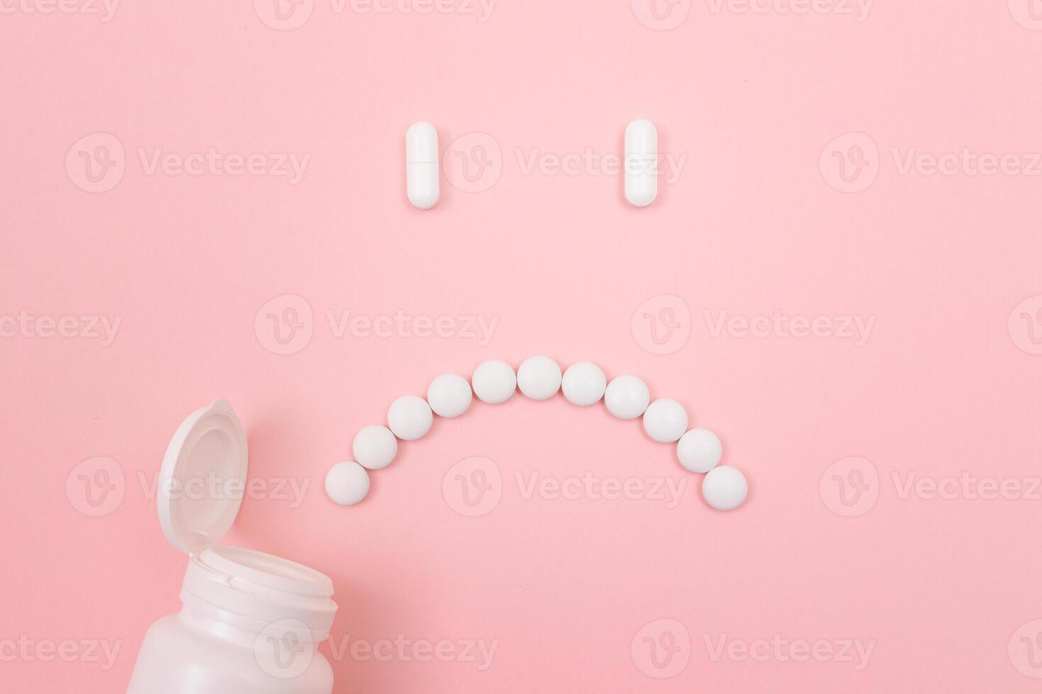 Pharma Harm. Sad Smiley Face Made from White Pills, Lying on Pink Backgrond. Global Pharmaceutical Industry and Medicinal Products photo