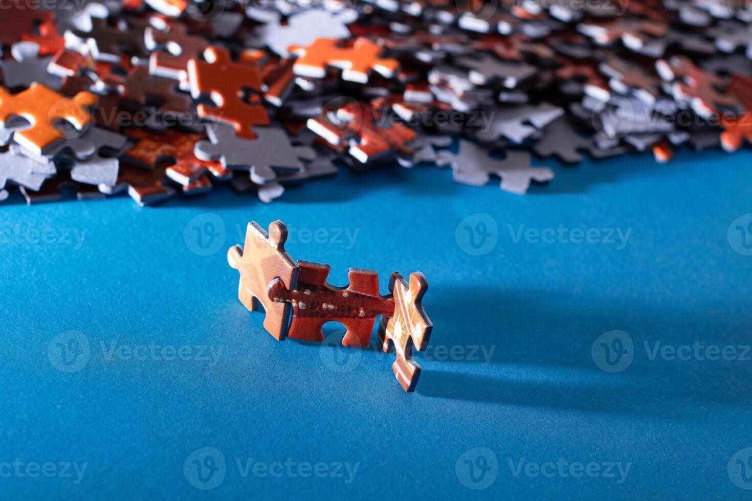 Mixed Pieces of a Colorful Jigsaw Puzzle Lie on the Blue Background - Strategy and Solving Problem Concept photo