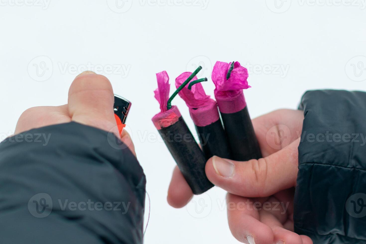 Guy Sets Fire to the Flash Noise Firecrackers Outdoors in Winter at Daytime. Loud and Dangerous New Year's Entertainment. Hooliganism with Pyrotechnics. Noise of Petards in Public Places photo