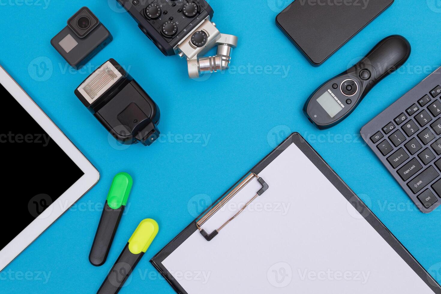 Top View of Photographer's, Videographer's or Blogger's Workplace. Digital Gadgets Lying on Blue Table - Flat Lay photo