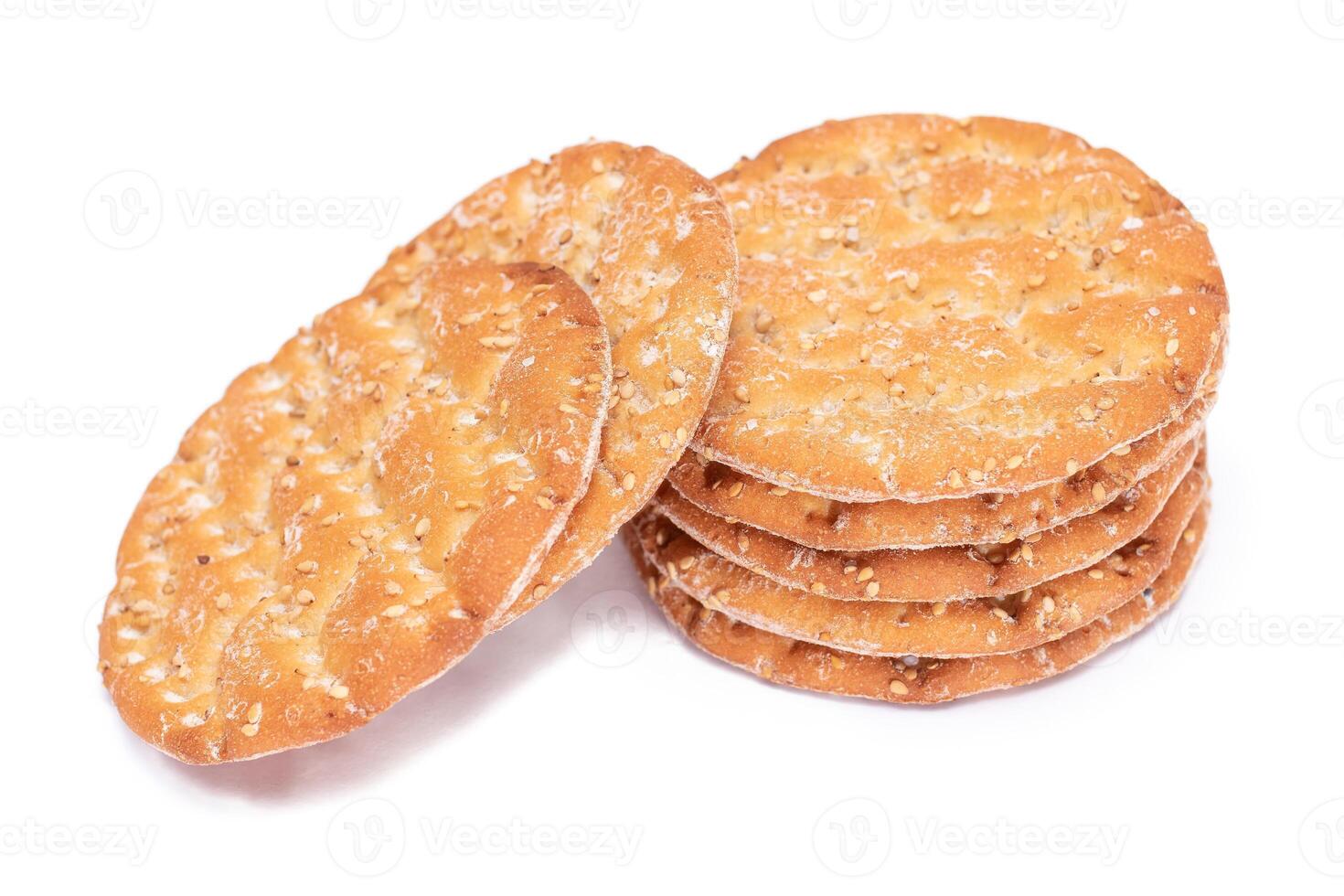 A Stack of Round Salt Crackers with Sesame Isolated on White Background. Dry Snacks - Isolation photo