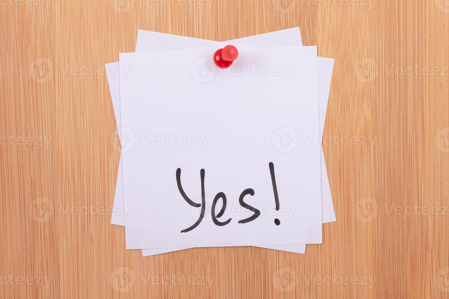 YES - White Sticky Notes with Written Word YES, Pinned to the Wooden Message Board. To Do List Reminder in the Office. Memo Note at Work photo