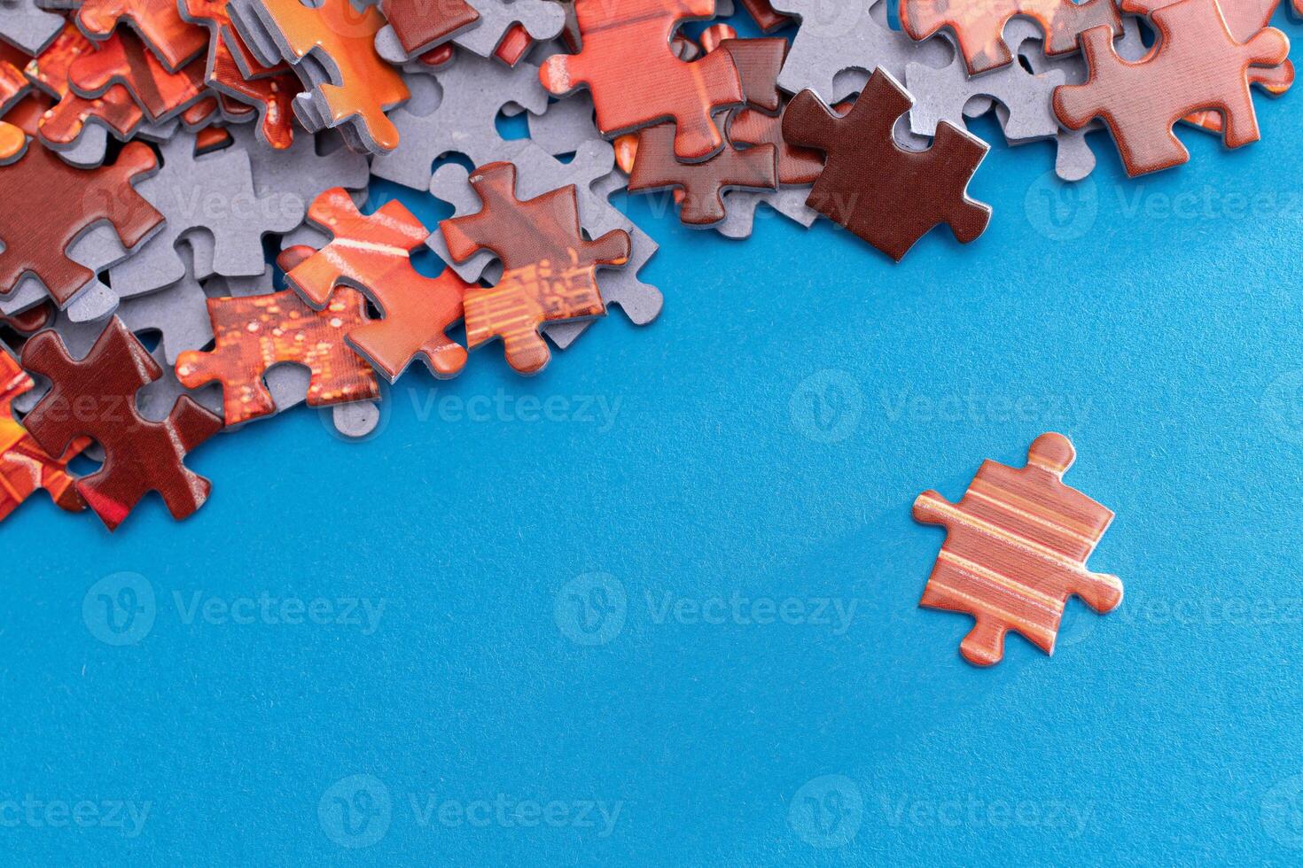 Mixed Pieces of a Colorful Jigsaw Puzzle Lie on the Blue Background - Strategy and Solving Problem Concept photo
