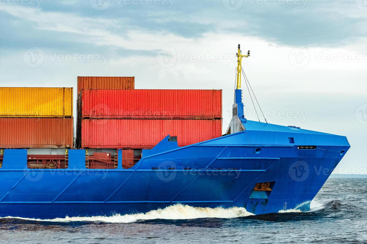 Blue cargo container ship fully loaded underway photo