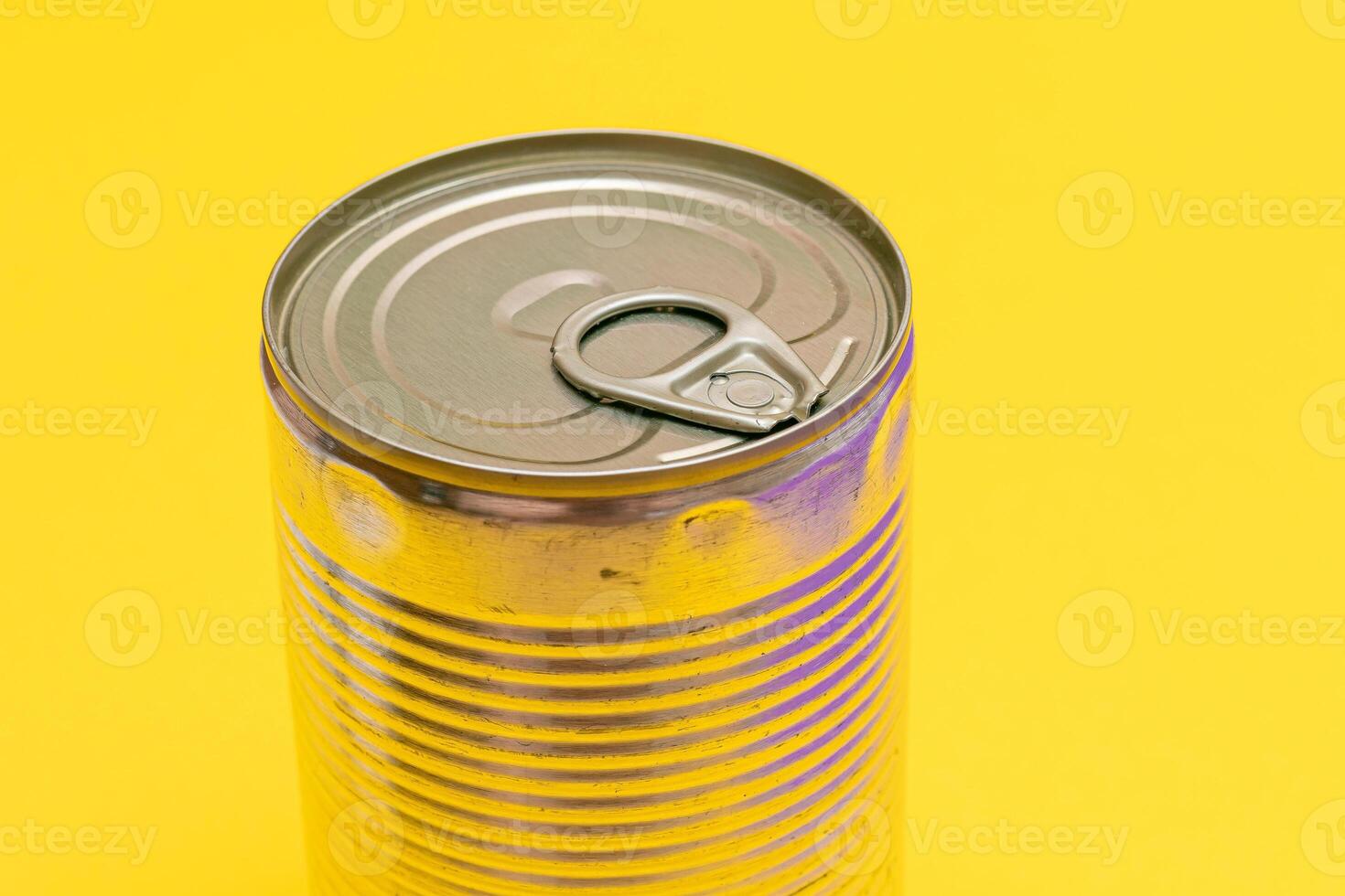 Unopened Tin Can with Blank Edge on Yellow Background. Canned Food. Aluminum Can for Safe and Long Term Storage of Food. Steel Sealed Food Storage Container photo