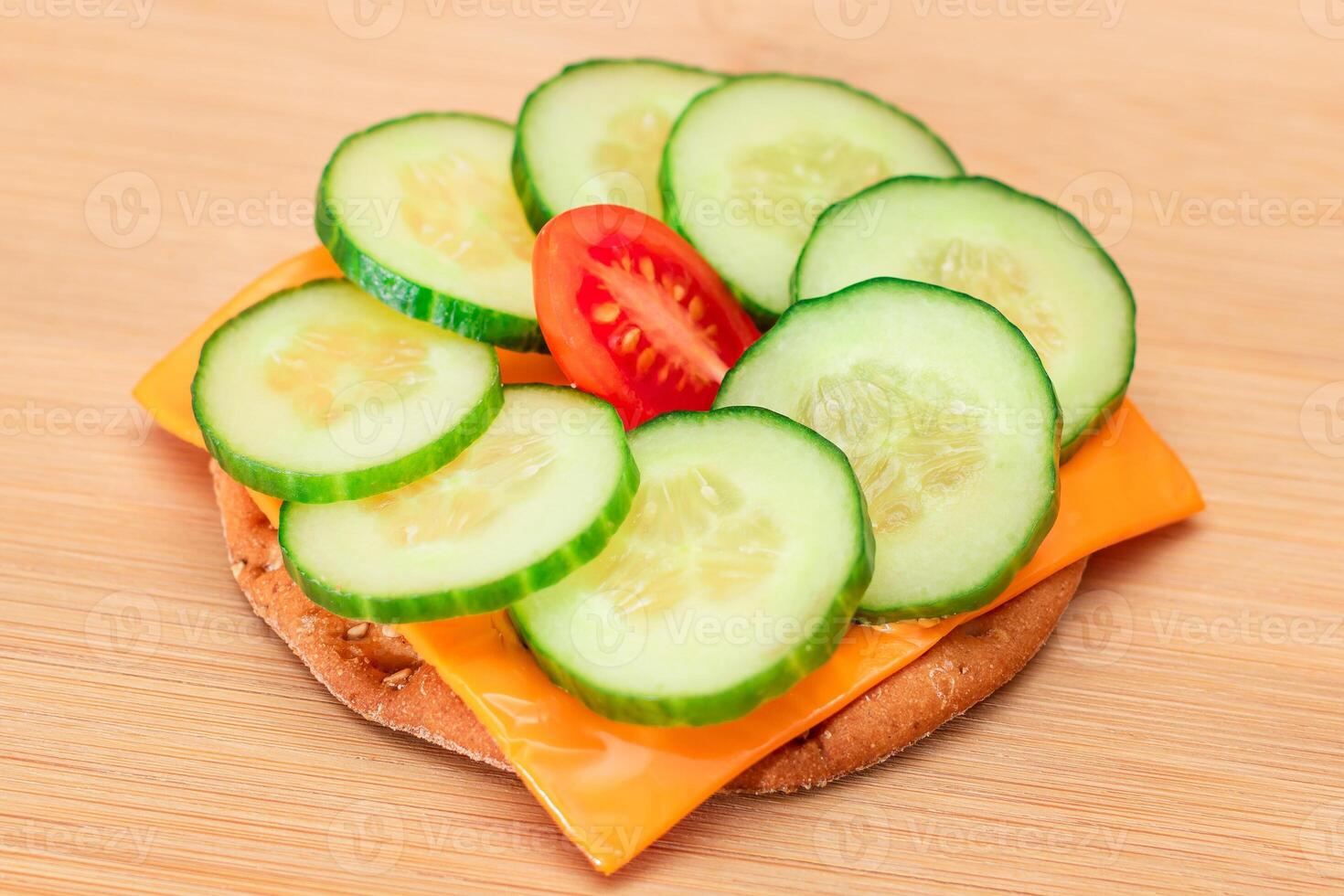 Crispy Cracker Sandwich with Fresh Cucumber, Tomato Cherry and Cheese on Cutting Board. Easy Breakfast. Diet Food. Quick and Healthy Sandwiches. Crispbread with Tasty Filling. Healthy Dietary Snack photo