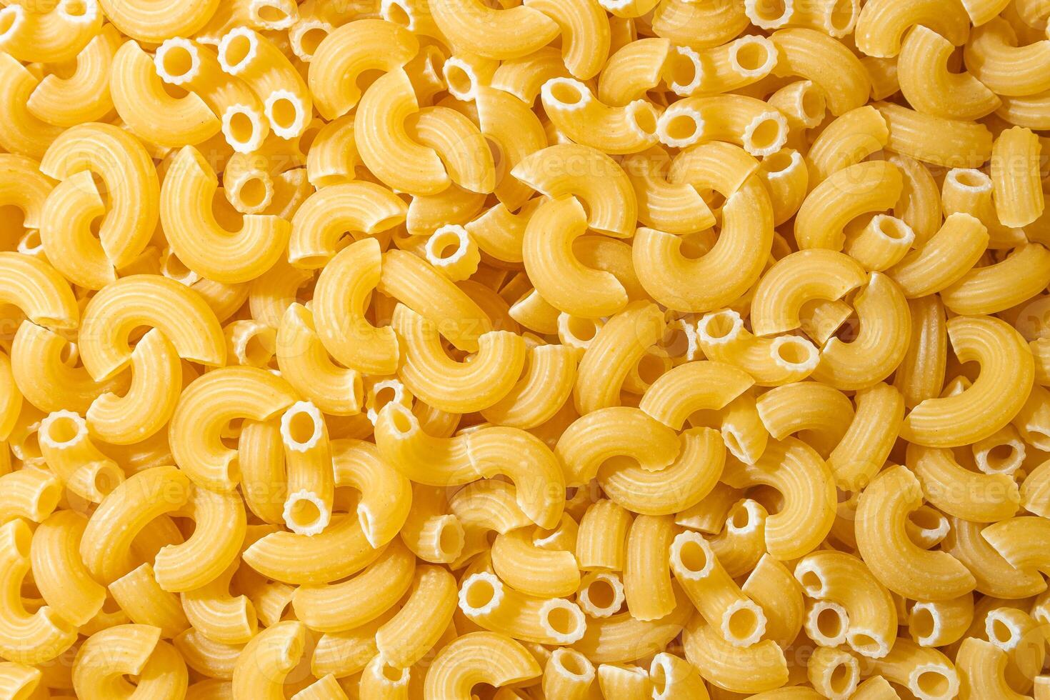 Uncooked Chifferi Rigati Pasta. A Culinary Canvas of Chifferi Rigati, Creating a Lively and Textured Background for Gourmet Cooking. Dry Pasta. Raw Macaroni - Top View, Flat Lay photo